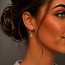 Silver dangle earrings with blue topaz